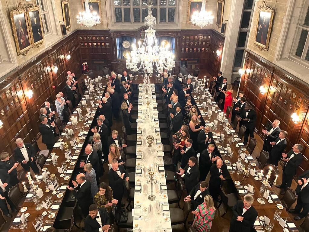 The full dining hall at Ironmongers' Hall — guests rising to applaud